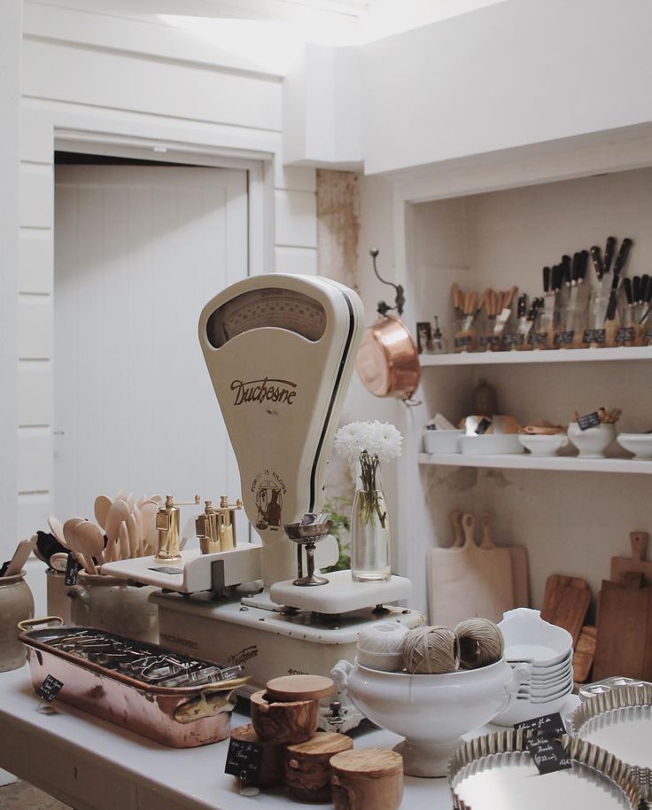 an old fashioned machine sitting on top of a counter next to plates and other items