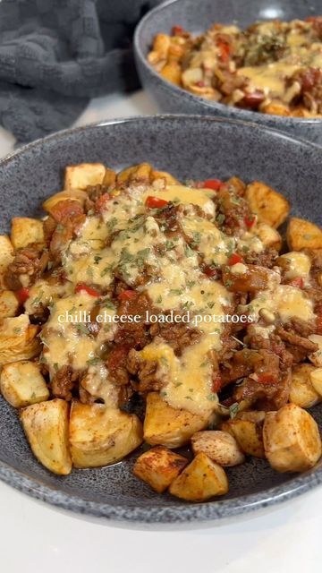 two bowls filled with food sitting on top of a table