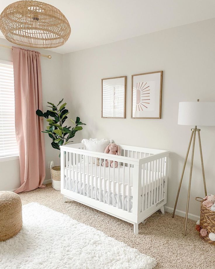 a baby's room with pink curtains and white crib