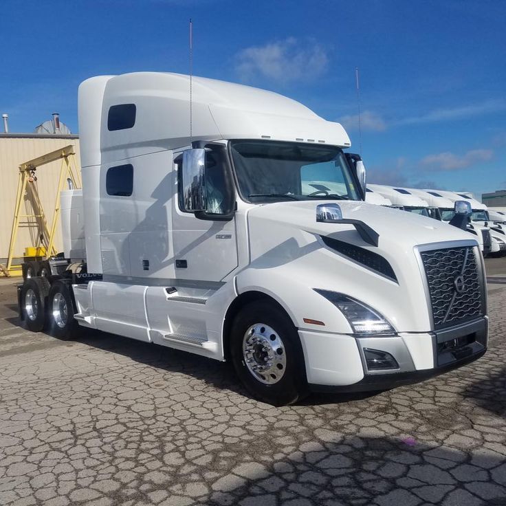 a white semi truck parked in a parking lot