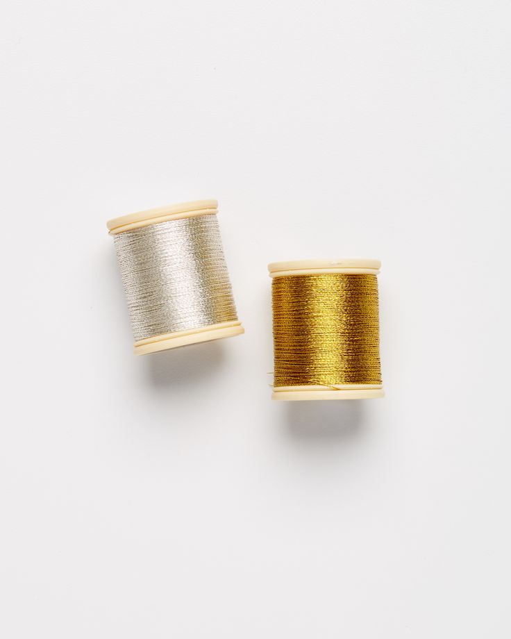 two spools of thread sitting next to each other