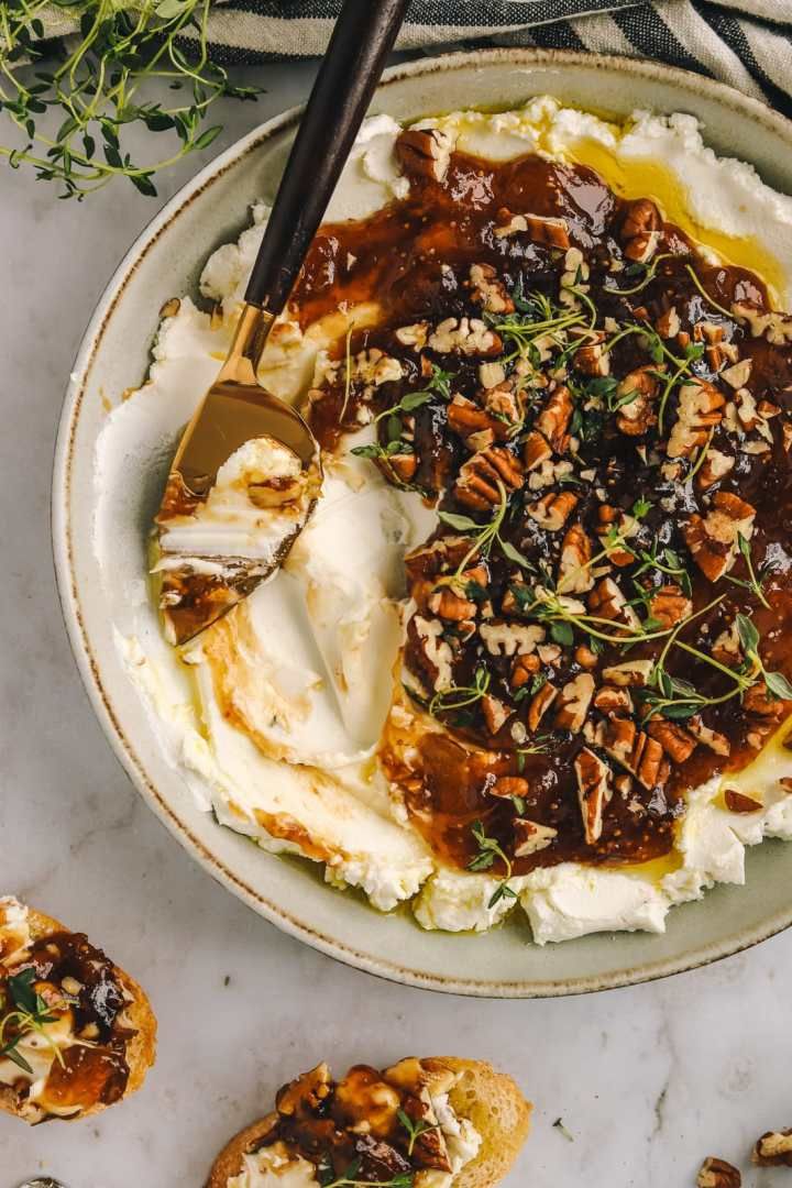 a bowl filled with mashed potatoes covered in gravy and topped with nuts