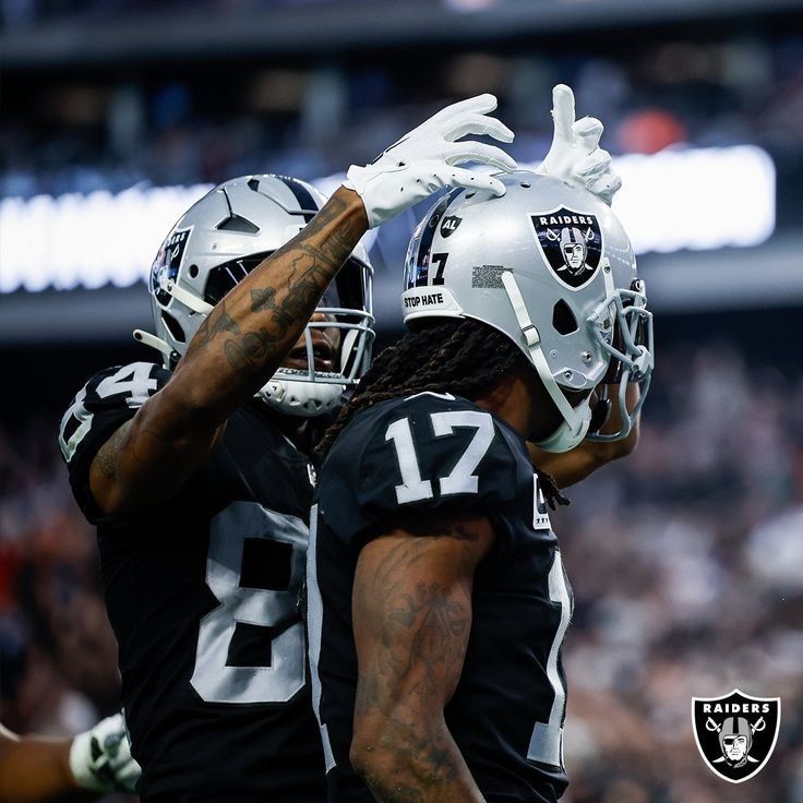 two oakland football players are congratulating each other