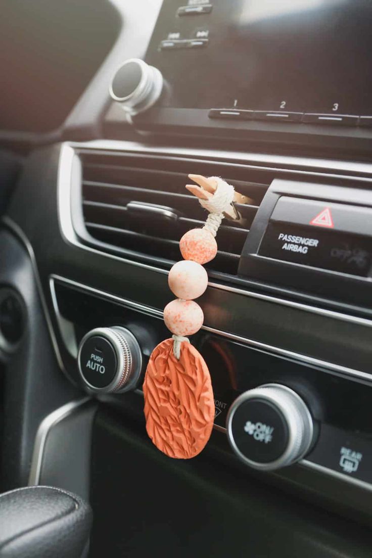 an air vent hanging on the dashboard of a car