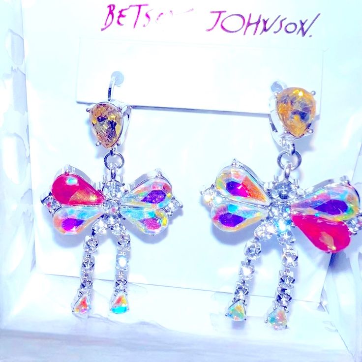 Brand-New Nwt New With Tags Betsey Johnson Bow Drop Statement Earrings. Gorgeous Iridescent Crystal Stones. Lever Back Closures. Approximately 2” In Length. Shipped In Their Original Betsey Johnson Box. Perfect Addition To Your Betsey Johnson Collection. 100% Authentic Guaranteed. Shipped Same To 1 Business Day. All Items Shipped Poshmark Priority 3 Day Mail. Party Multicolor Sterling Silver Earrings, Multicolor Sterling Silver Party Earrings, Multicolor Sterling Silver Earrings For Party, Iridescent Crystal, Betsey Johnson Jewelry, Statement Drop Earrings, Betsey Johnson, Stones And Crystals, Statement Earrings