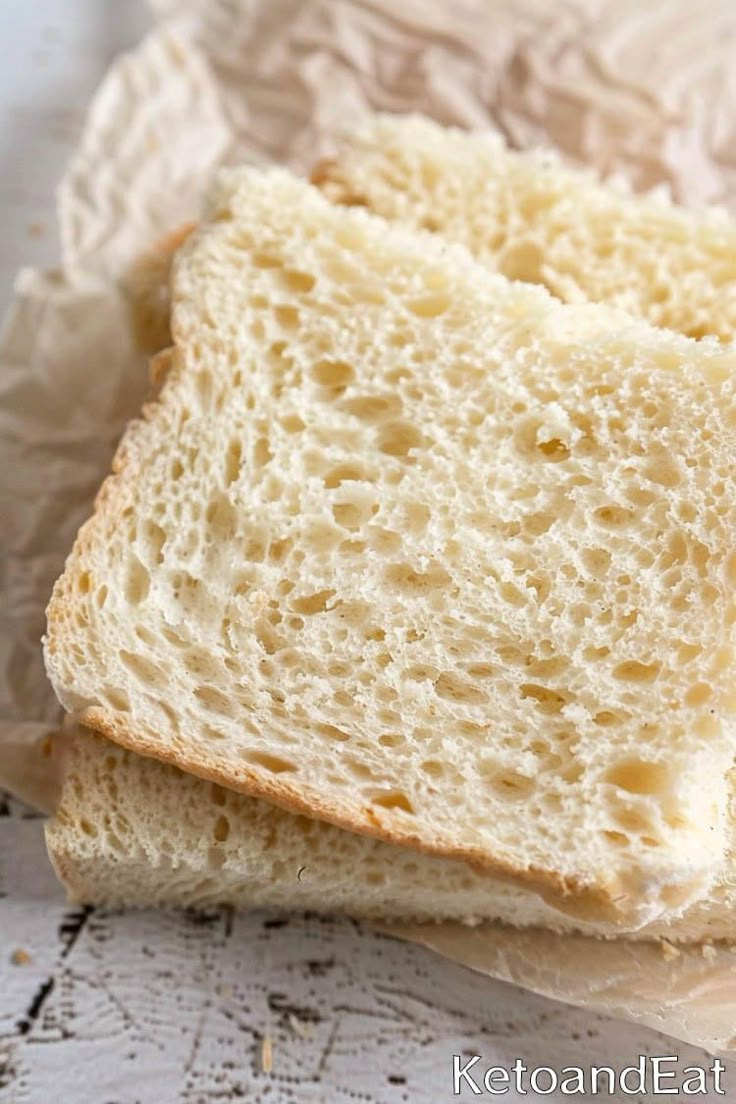 two slices of white bread sitting on top of paper