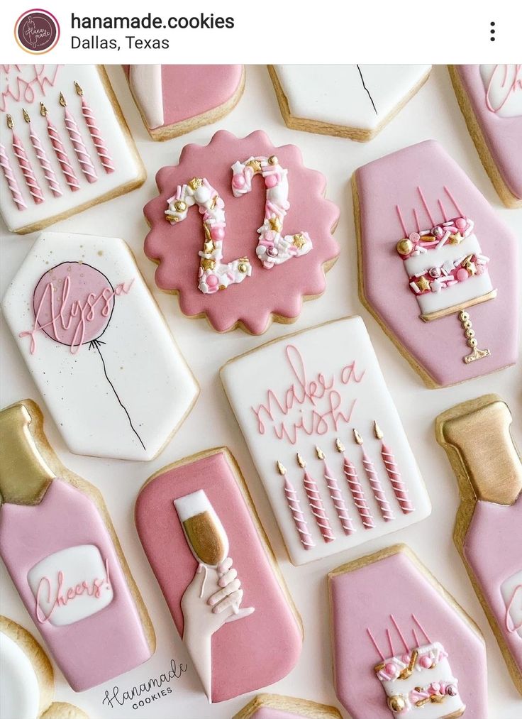 cookies decorated with pink and gold icing are arranged on a white tablecloth that says,