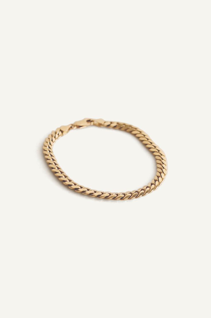 In some cultures, gold bracelets or anklets are given to newborns. They are known to bring luck and great fortune, or to protect one against evil spirits. In reminiscence of Jennie's gold ID bracelet that she received from her grandmother, this bracelet is a modern take on a vintage piece from the 80's. Chain links are not entirely flat and have a rounded texture for a comfortable fit.Lobster clasp closure. In the second image, model is wearing the Hampshire House Bracelet, Capri Curb Chain Brac Italian Gold Chain, Hampshire House, Italian Gold Jewelry, Cuban Bracelet, Safety Box, Fall Rings, Gold Baroque, Bar Stud Earrings, Star Pendant Necklace