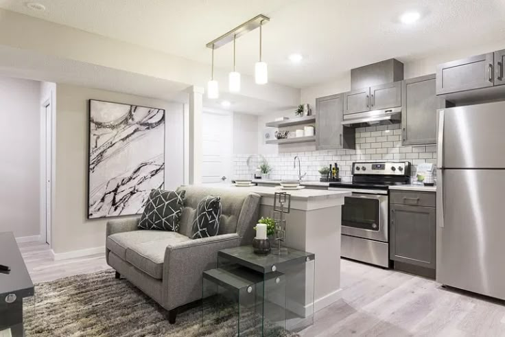 a kitchen and living room with stainless steel appliances