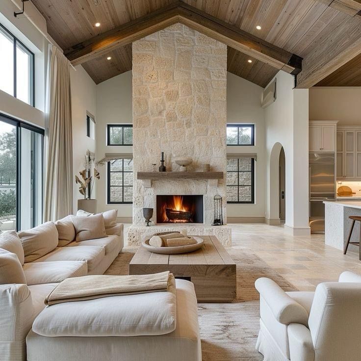 a living room filled with furniture and a fire place in the middle of a room