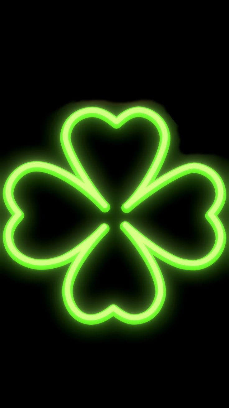 a four leaf clover neon sign on a black background for st patrick's day