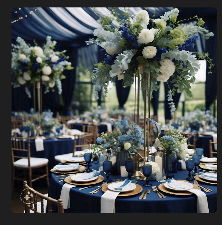 a table set up with blue and white flowers