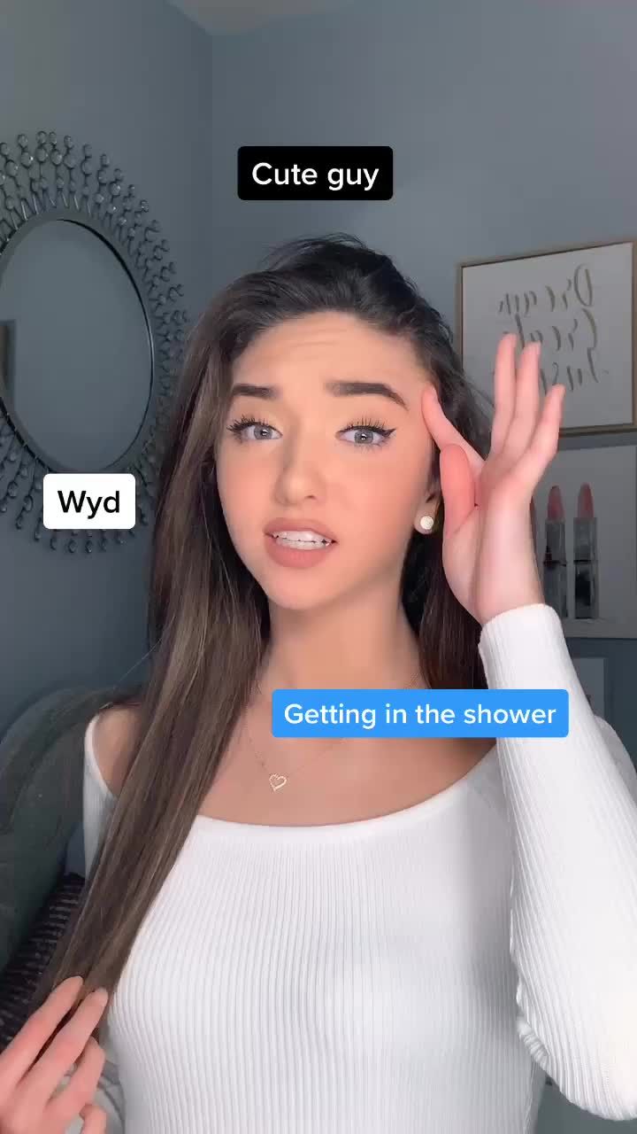 a woman with long brown hair is holding her hand up to her face and the text, cute guy wyd getting in the shower