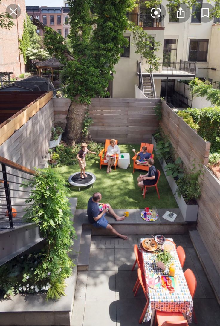 an overhead view of a small backyard with people sitting at the table and eating food