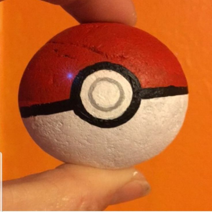 someone is holding a pokemon ball in their hand