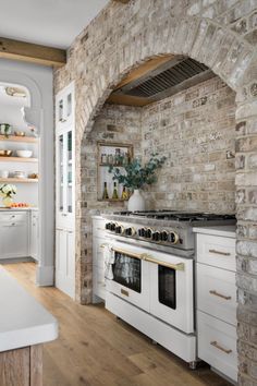 a white stove top oven sitting inside of a kitchen next to a wall mounted oven