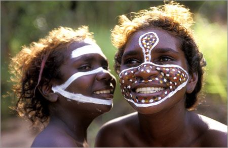 two women with painted faces are kissing each other