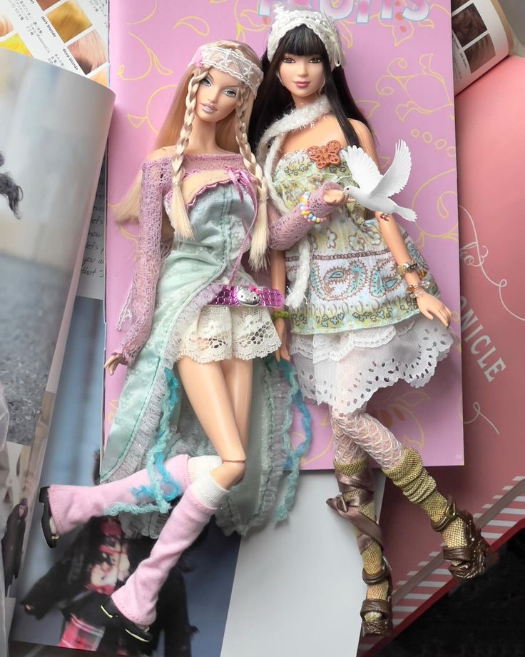 two dolls are posed next to each other