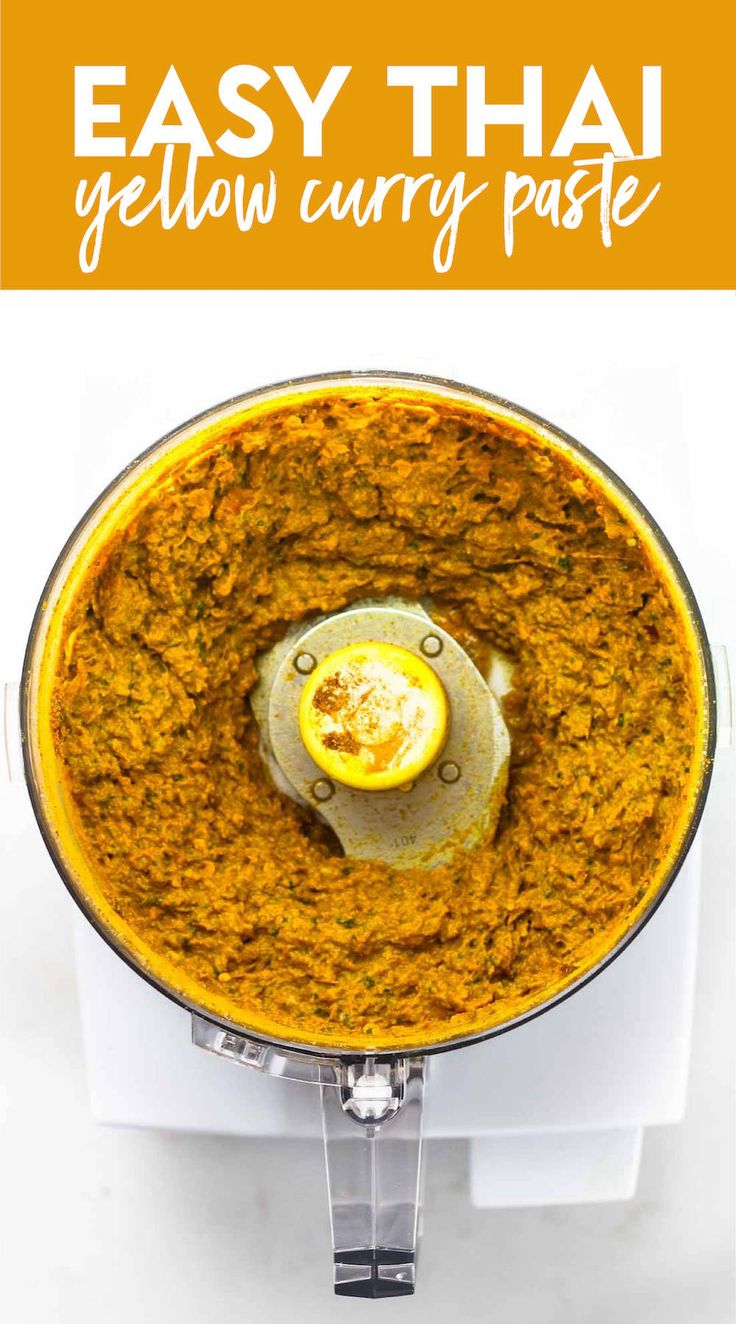 a yellow curry paste in a food processor with text overlay that reads easy thai yellow curry paste