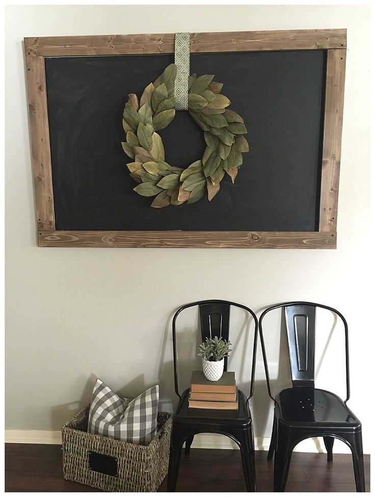 two chairs and a chalkboard with a wreath on it