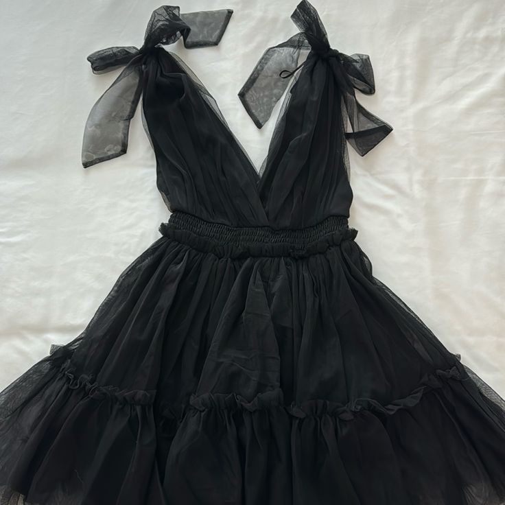 Black Tulle Mini Dress With Shoulder Bow Ties Black Tulle Mini Dress, Flirty Black Mini Dress For Prom, Black Flirty Mini Dress For Casual Wear, Black Flirty Dress For Spring, Flirty Black Dress For Spring, Black Summer Cocktail Dress, Black Mini Dress For Casual Summer Wear, Black Mini Dress For Casual Summer Days, Tulle Mini Dress