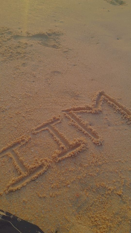 a sign that is written in the sand