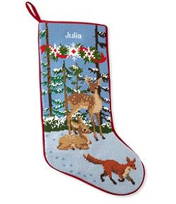 a christmas stocking with an image of two deers and a fox in the snow