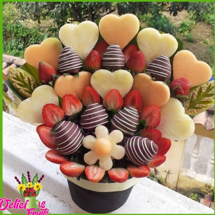 a vase filled with chocolate covered strawberries and hearts