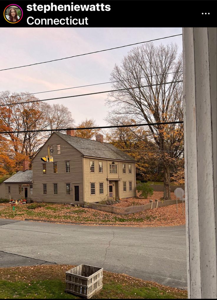 an old house sits in the middle of a rural area with power lines above it