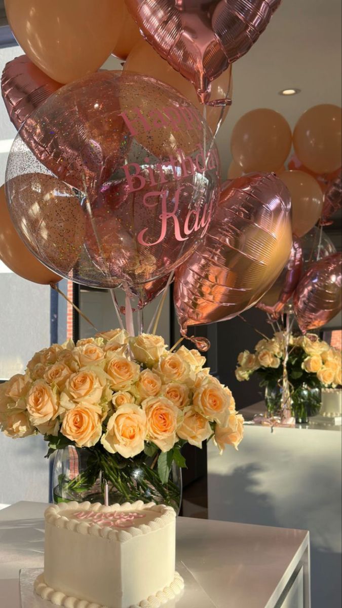 a cake and some balloons on a table