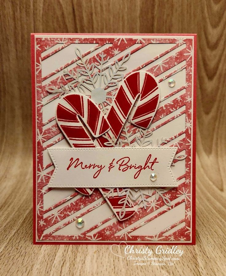 a close up of a card with two hearts on it and the words merry and bright