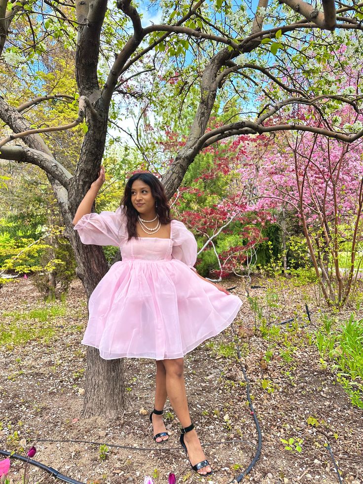 Pink Organza Babydoll Dress This is the babydoll dress for a dramatic, pink-loving princess. It's made entirely of high-quality sheer organza fabric, which makes it the puffiest, most dramatic babydoll dress in all of our collections! The skirt is made of three layers and the top is double-layered. Both the sleeves and top maintain their sheerness. All of the seams are inside the layers to prevent fraying and itchiness. The elastic at the bottom of the sleeve creates a ruffle effect at the elbow. It closes at the back with an invisible zipper. Model is 5'2" wearing a size small. Organza Fabric, Three Layer, Pink Princess, Kind Heart, Babydoll Dress, Invisible Zipper, Dresses Xs, Pink Dress, Baby Dolls