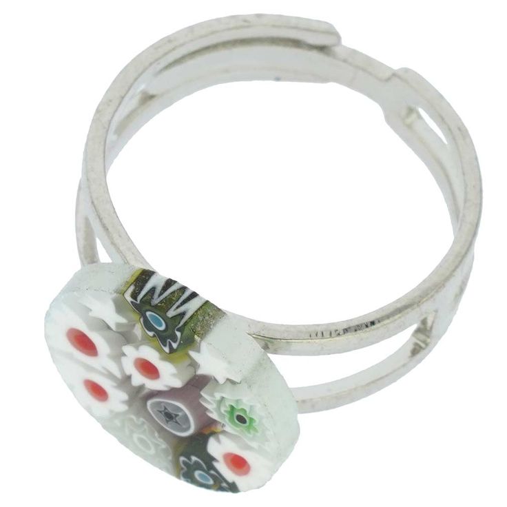 Unique and elegant, this Venetian ring is hand-made using the most famous Murano glass technique- Millefiori (a thousand flowers)- which has become a trademark of Murano glass making. This easily-recognizable Murano glass accessory features a symmetric eye-catching pattern of colorful stylized flowers in rich hues, which will add a touch of authentic Venetian style to any outfit. Pair this Murano ring with a Millefiori pendant and earrings from our extensive Millefiori collection for a perfectly Italian Leather Handbags, Italian Bags, Murano Glass Jewelry, Glass Christmas Tree Ornaments, Handmade Handbags, Glass Rings, Elegant Accessories, Office Accessories, Watches Jewelry