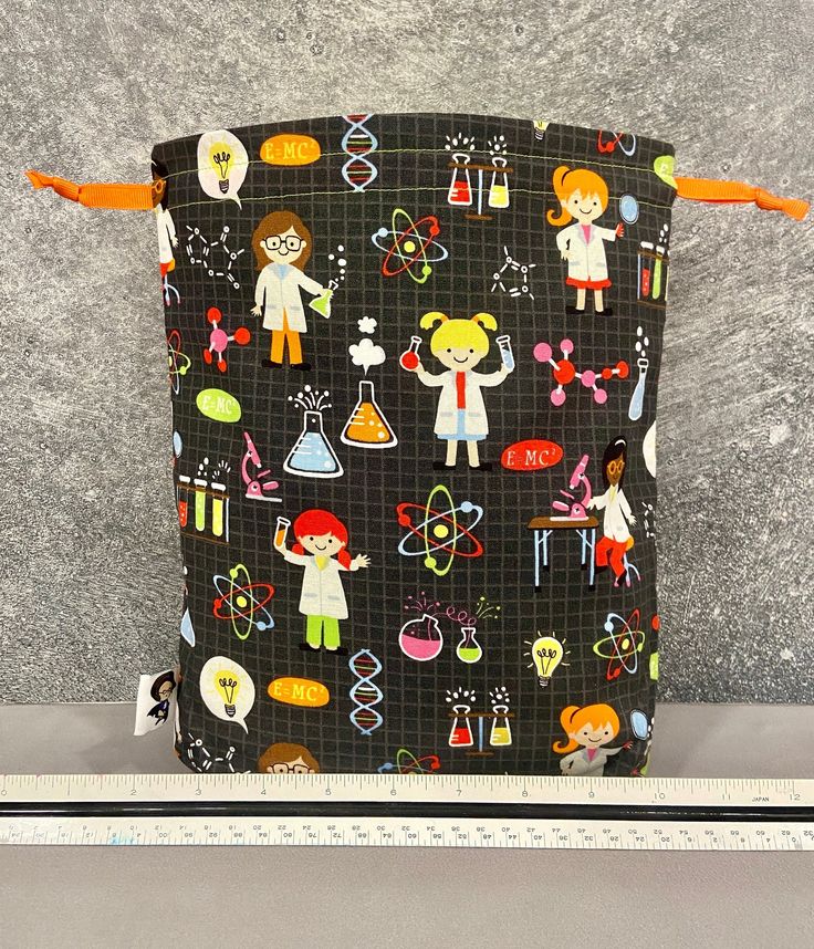 the back side of a black bag with children's drawings and symbols on it