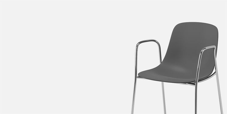 a gray chair sitting on top of a white floor next to a metal leg rest