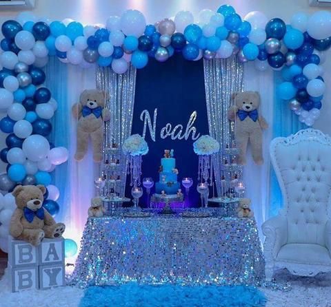 a baby shower decorated with blue and white balloons, teddy bears, and other decorations