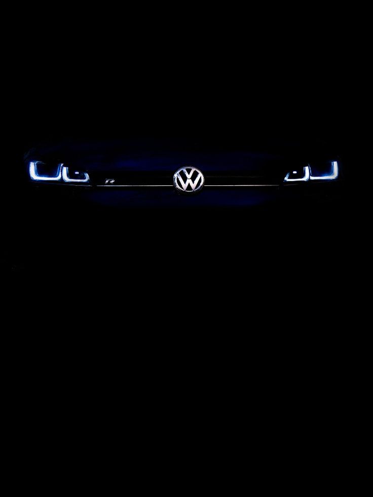 the volkswagen logo is glowing in the dark