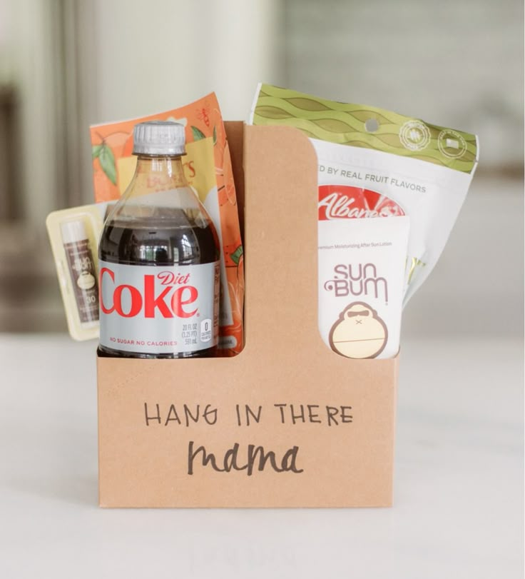 a bottle of coke and some snacks in a box