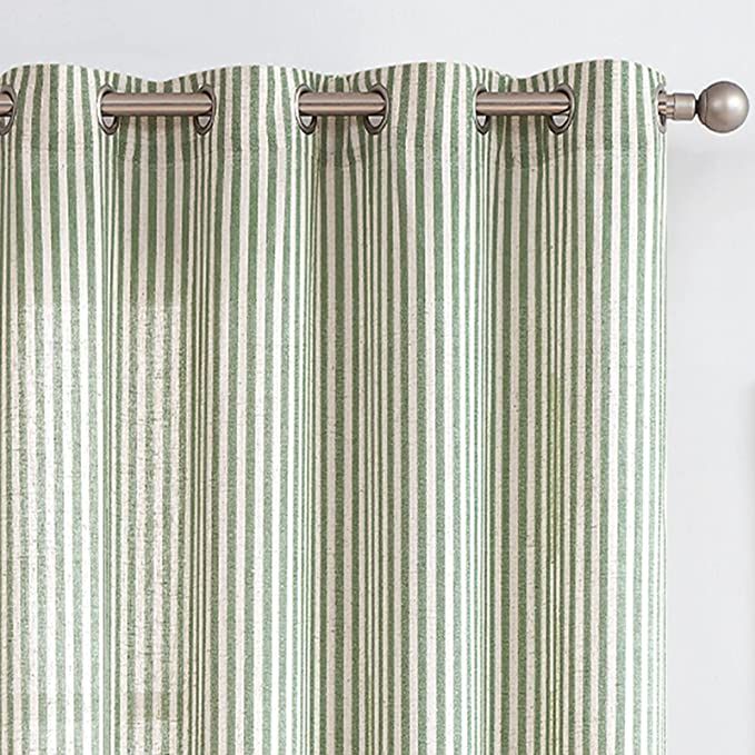 green and white striped curtains hanging on the side of a window with metal rods in front of it