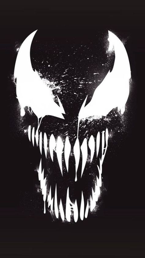 a black and white image of a monster's face with fangs on it, in the dark