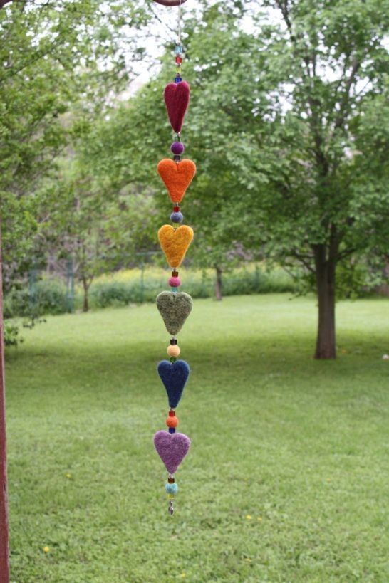 a colorful wind chime hanging from a tree