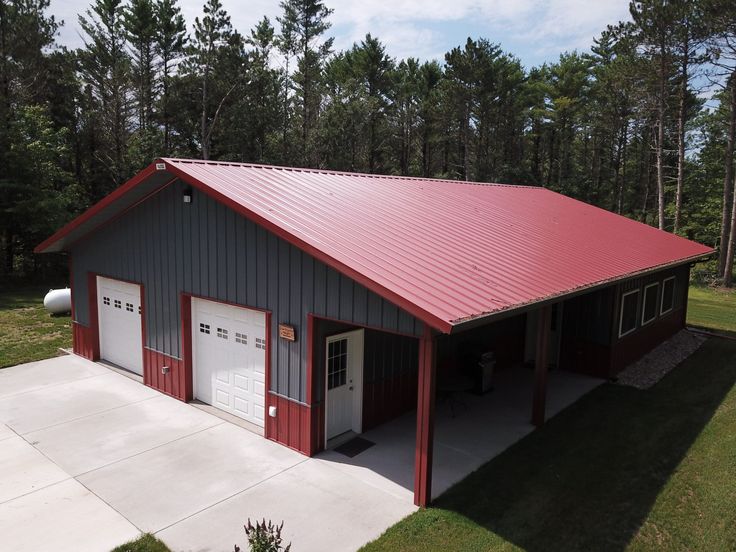 an overhead garage with two doors and a red roof