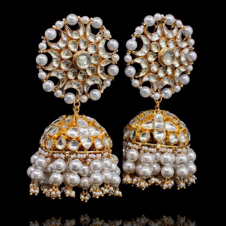 Radiant sheer elegance with this showstopper worthy set- inspired by Aiman Khan's stunning grace at Minal Khan's wedding! Stunning jhumkey earrings and a maang teekah set with a classic combination of kundan stones and pearl moti. Approximate earrings length is 3.25". Gold-plated on high-quality brass as base metal. Made by order. Kindly allow 5-7 weeks for the delivery of this item. For custom or urgent requests, please contact support@alacouture.com. *Please Note: We use faux stones and beads Bollywood Chandbali Bridal Accessories For Wedding, Chandbali Bridal Accessories With Stone Work For Wedding, Wedding Bridal Chandbali Accessories With Stone Work, Traditional Chandbali Bridal Accessories For Wedding, Festive Bridal Sets With Mirror Work For Wedding, Festive Bridal Set With Mirror Work For Wedding, White Traditional Wedding Wear With Tilla, Kundan Wedding Jewelry With Stone Work, Traditional Kundan Bridal Accessories