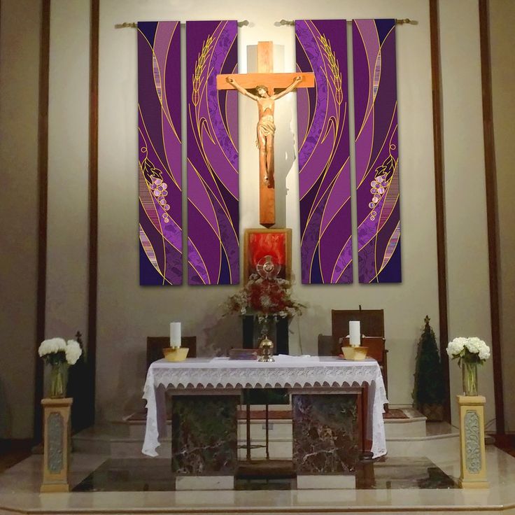 an altar with flowers and candles in front of a painting on the wall behind it