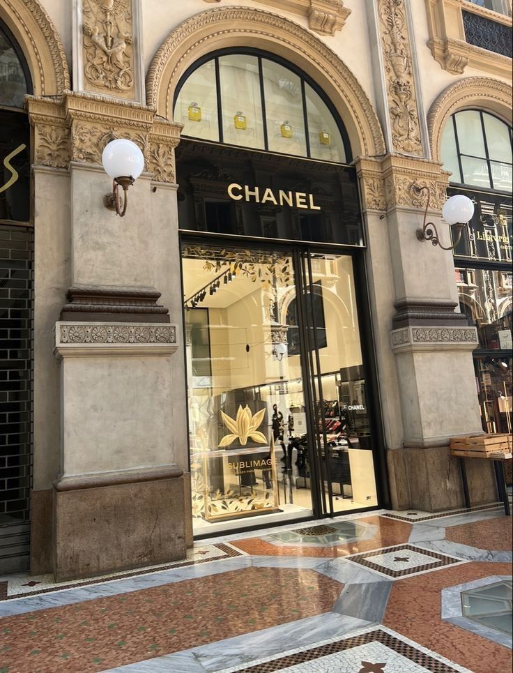 a chanel store front with its glass windows and gold trimmings on the doors