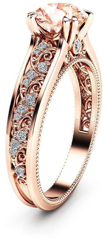 a rose gold engagement ring set with an oval cut center stone and side stones on the band