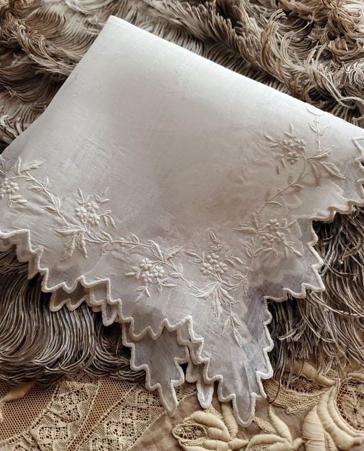 an old piece of cloth with white lace on it