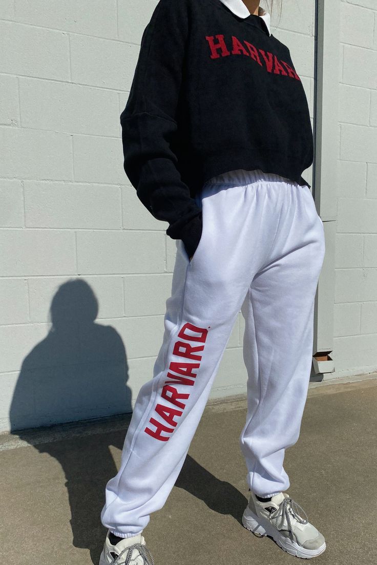 A must have! Stay comfy all season long in the our Harvard Basic Sweatpants. These sweatpants feature a high-rise fit, elastic waistband, side pockets, and cuffed ankles. High-rise Elastic waistband Side pockets Cuffed ankles 75% Cotton, 25% Polyester Machine washable Size + Fit Wearing size S Height: 5'5" P.S. We'd love to see you repping this style! Don't forget to tag us to be featured ♡ *All MTO orders are made specifically for you. Please allow 3-6 business days for order to be processed an Sweatpants Outfit Street Styles, Comfy Outfit For School, Theodore Nott, Comfy School Outfits, Mha Dr, Vinyl Logo, Sweats Outfit, Tailgate Outfit, University Outfit