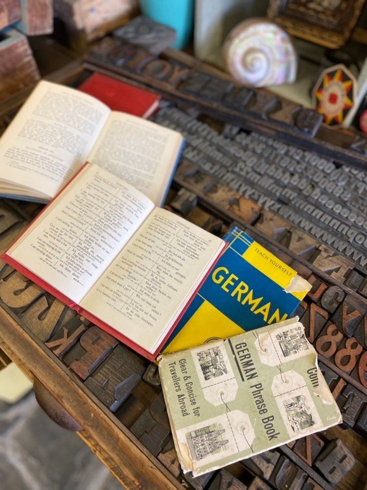 an open book sitting on top of a table next to some type of letters and numbers