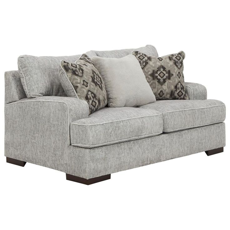 a gray couch with pillows on it